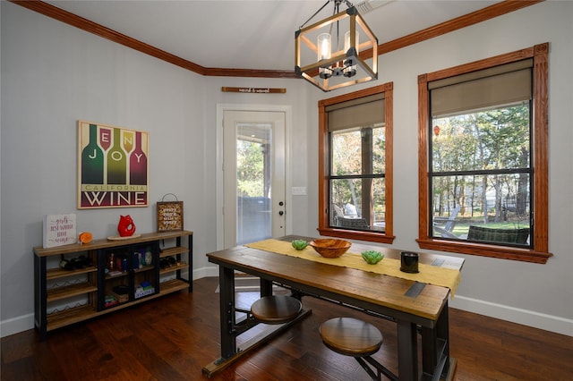 dining room with ornamental molding, dark wood-style flooring, a notable chandelier, and baseboards