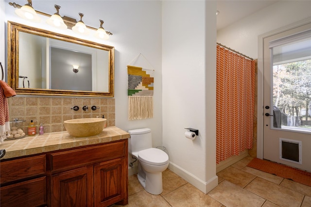 full bathroom with toilet, tile patterned flooring, backsplash, and vanity