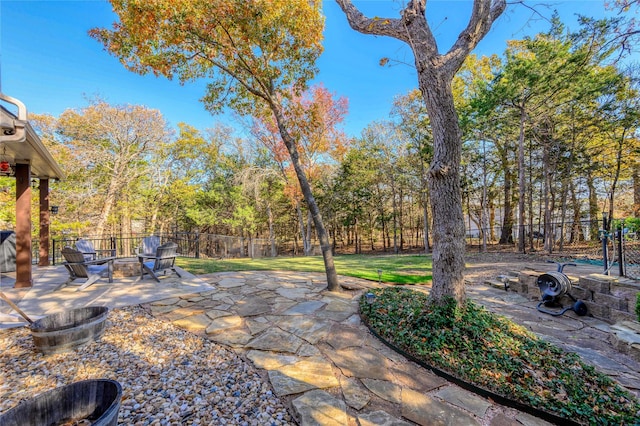 view of yard with an outdoor fire pit, a patio area, and a fenced backyard