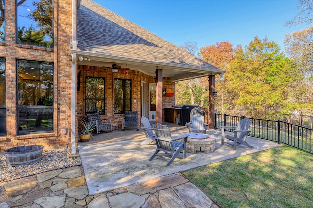 view of patio featuring ceiling fan, an outdoor fire pit, grilling area, and fence