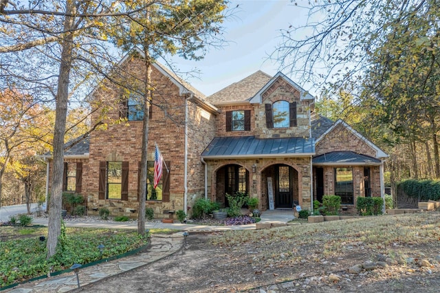 588 Lakepoint Loop, Pottsboro, TX 75076 - traditional-style house featuring covered porch, brick siding, and a standing seam roof