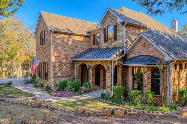 588 Lakepoint Loop, Pottsboro, TX 75076 - tudor-style house with a shingled roof, brick siding, and a chimney