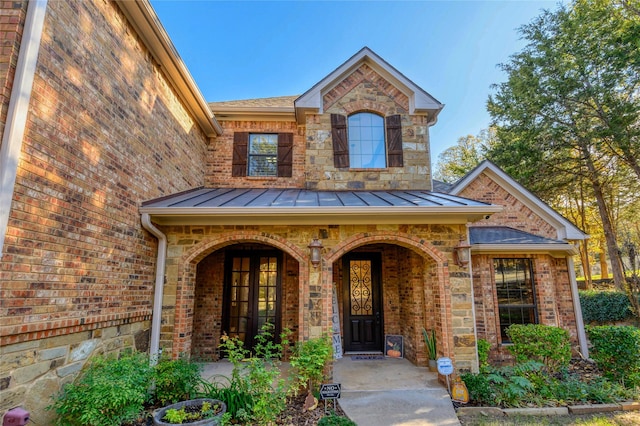 588 Lakepoint Loop, Pottsboro, TX 75076 - doorway to property featuring brick siding, covered porch, a standing seam roof, and roof with shingles