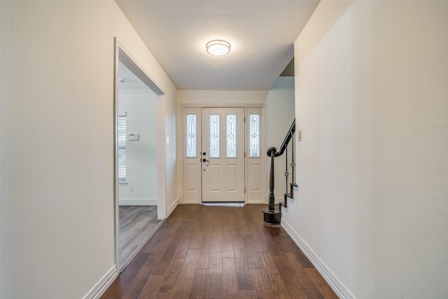 entryway featuring dark hardwood / wood-style flooring and a textured ceiling