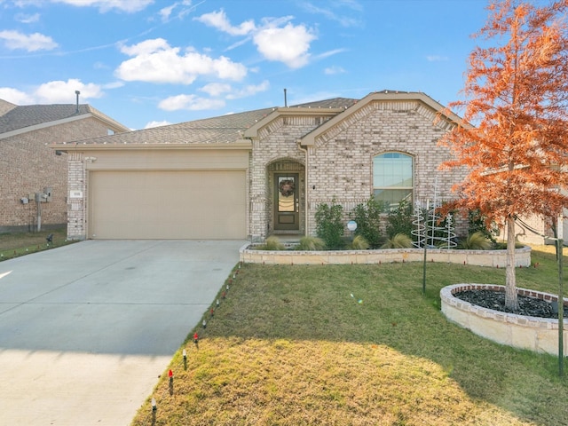 view of front of property with a garage and a front lawn