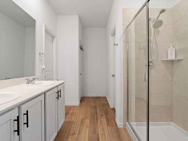 bathroom with vanity, hardwood / wood-style flooring, and an enclosed shower