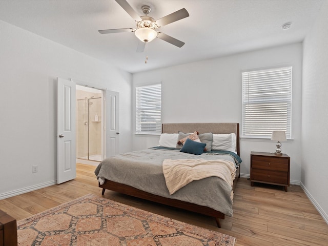 bedroom with light hardwood / wood-style flooring, ceiling fan, and ensuite bathroom