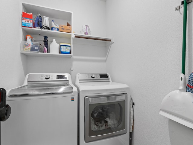 clothes washing area featuring separate washer and dryer