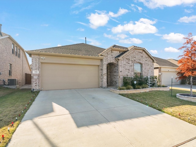 view of front of property featuring central AC, a front yard, and a garage