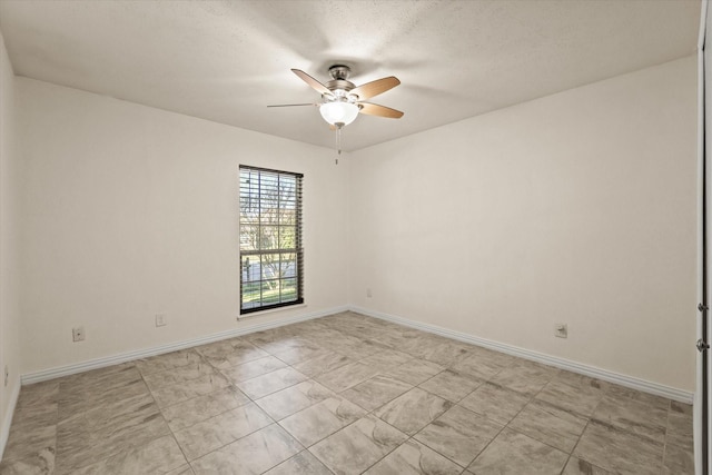 spare room with ceiling fan and a textured ceiling