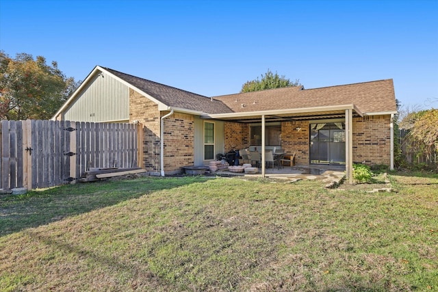 rear view of property featuring outdoor lounge area, a yard, and a patio area