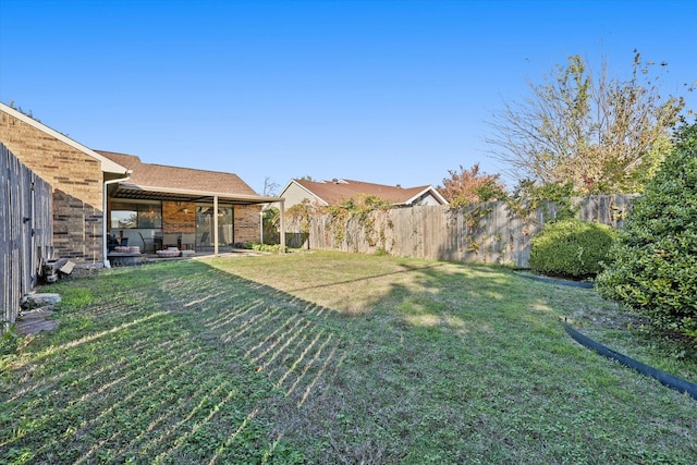 view of yard featuring ceiling fan and a patio