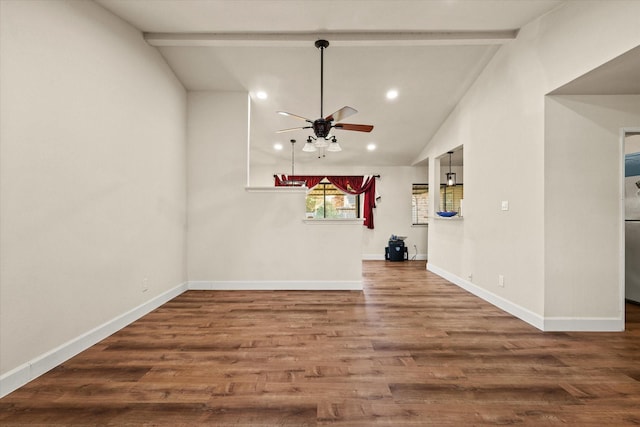 unfurnished living room featuring hardwood / wood-style floors, lofted ceiling with beams, and ceiling fan