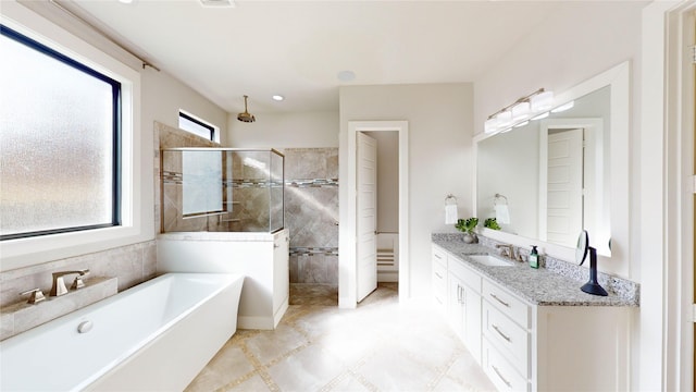 bathroom featuring vanity and separate shower and tub