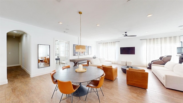 dining area with light hardwood / wood-style floors, ceiling fan, and a healthy amount of sunlight