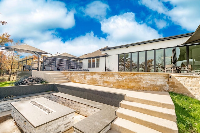 view of patio / terrace featuring an outdoor fire pit