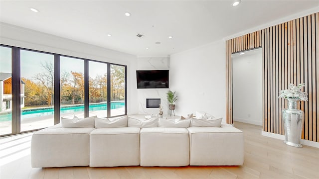 living room featuring light hardwood / wood-style flooring and ornamental molding