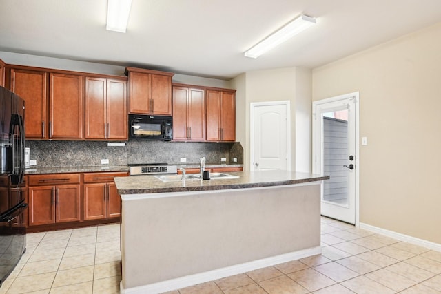 kitchen featuring black appliances, backsplash, light tile patterned floors, and a kitchen island with sink