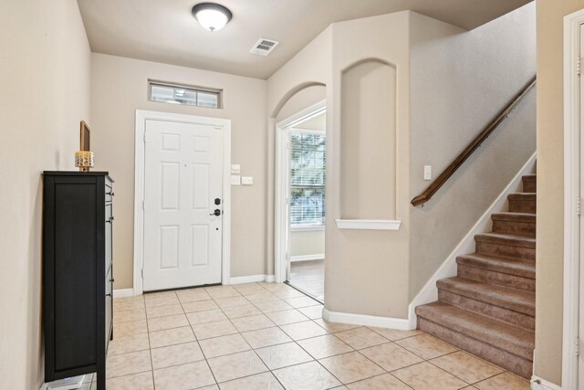 2812 Merry View Ln, Fort Worth, TX 76120 - foyer featuring baseboards, visible vents, stairway, and light tile patterned floors