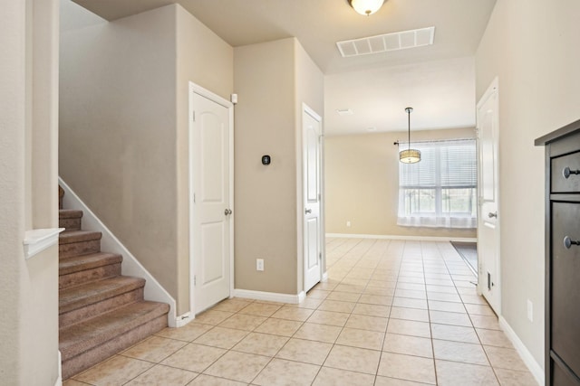 2812 Merry View Ln, Fort Worth, TX 76120 - interior space featuring light tile patterned flooring, stairs, visible vents, and baseboards