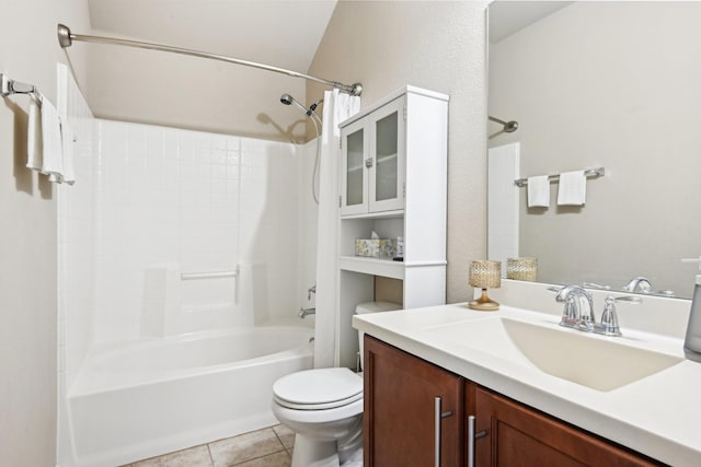 full bathroom featuring vanity,  shower combination, lofted ceiling, tile patterned floors, and toilet