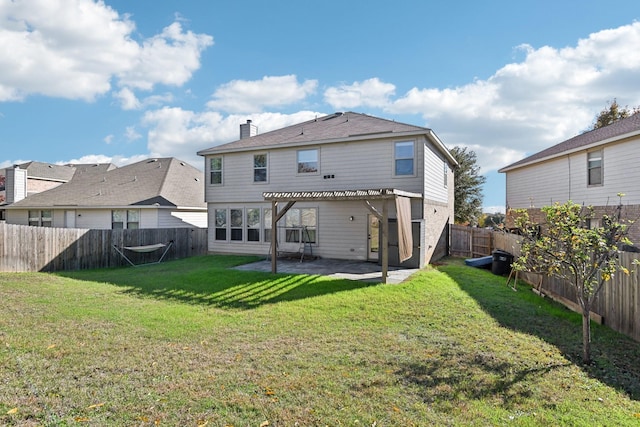 back of house with a patio and a lawn