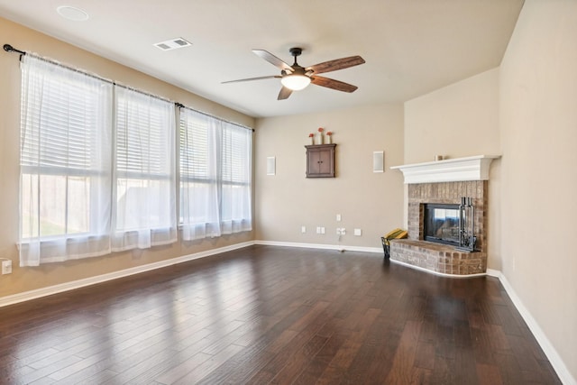 2812 Merry View Ln, Fort Worth, TX 76120 - unfurnished living room with a brick fireplace, baseboards, visible vents, ceiling fan, and dark wood-type flooring