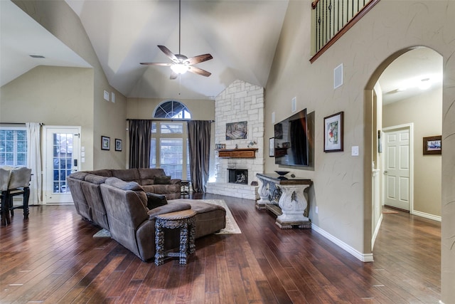 living room featuring dark hardwood / wood-style floors, high vaulted ceiling, and a wealth of natural light