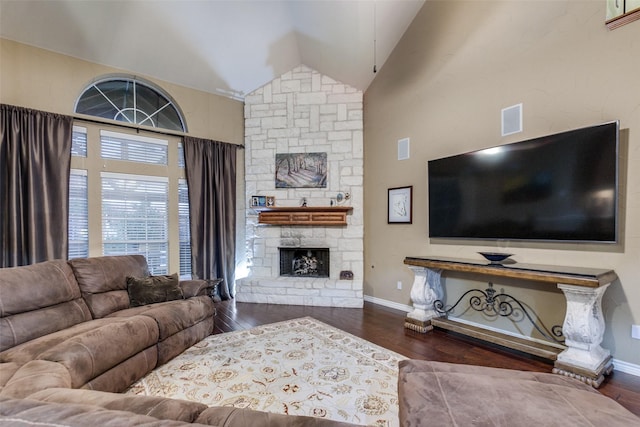 living room featuring dark hardwood / wood-style floors, a fireplace, and high vaulted ceiling