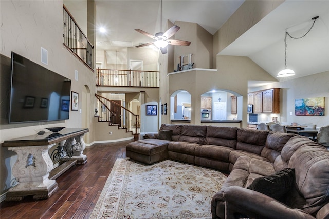 living room with ceiling fan, dark hardwood / wood-style flooring, and high vaulted ceiling