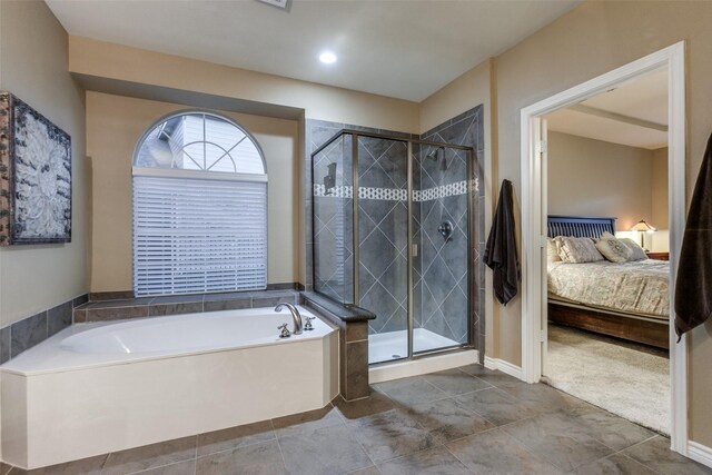 bathroom featuring separate shower and tub