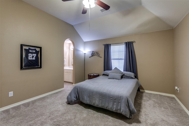 carpeted bedroom with connected bathroom, ceiling fan, and lofted ceiling