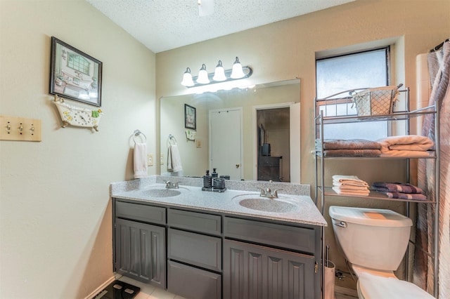 bathroom with vanity and a textured ceiling