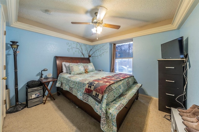 bedroom with ceiling fan, carpet, and a textured ceiling