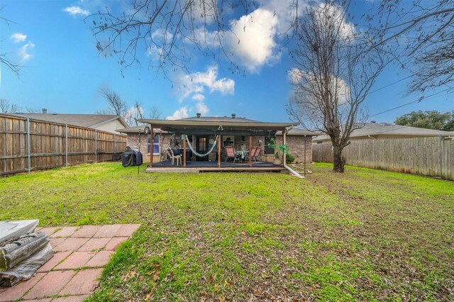 back of house featuring a wooden deck and a lawn