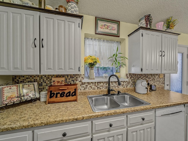 kitchen with sink, a textured ceiling, white cabinets, and dishwasher