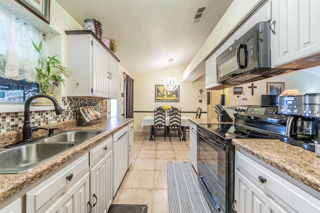 kitchen with hanging light fixtures, black appliances, sink, and white cabinets