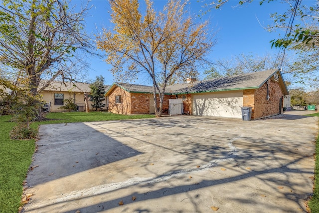 single story home with a garage and a front yard