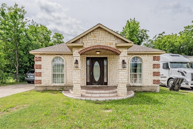 5613 Graham St, Sansom Park, TX 76114 - french country home with a shingled roof, a front lawn, and stone siding