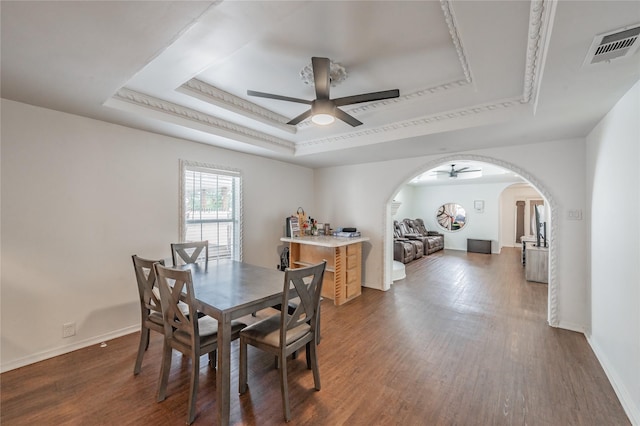 5613 Graham St, Sansom Park, TX 76114 - dining space featuring ceiling fan, a raised ceiling, wood finished floors, and arched walkways
