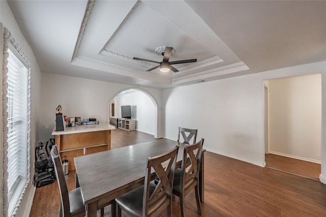 5613 Graham St, Sansom Park, TX 76114 - dining space featuring a raised ceiling, a ceiling fan, dark wood-style flooring, arched walkways, and baseboards