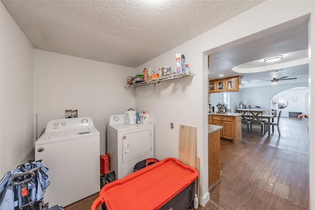 5613 Graham St, Sansom Park, TX 76114 - laundry room with washing machine and dryer, a textured ceiling, wood finished floors, a ceiling fan, and arched walkways