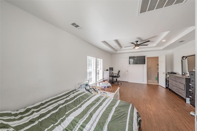 5613 Graham St, Sansom Park, TX 76114 - bedroom featuring dark wood-style flooring, a tray ceiling, and a ceiling fan