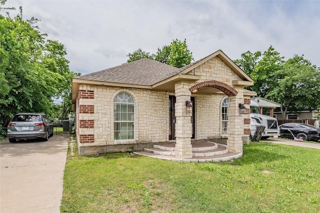 5613 Graham St, Sansom Park, TX 76114 - french country home with a shingled roof, a front lawn, and stone siding