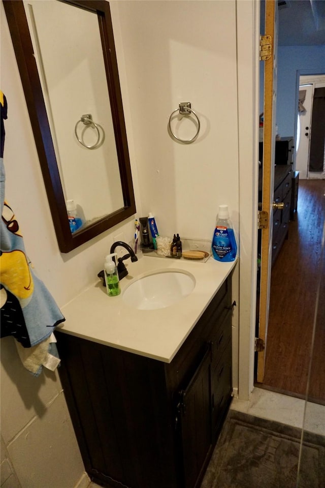 bathroom with hardwood / wood-style floors and vanity