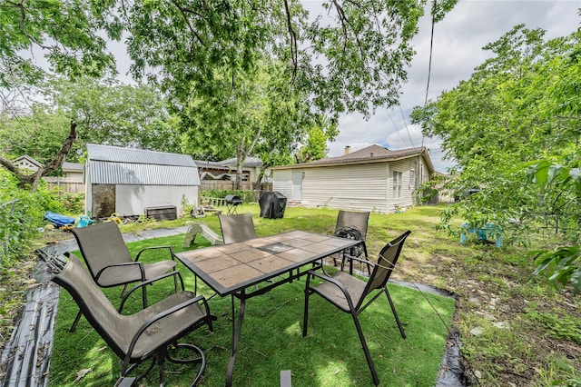 5613 Graham St, Sansom Park, TX 76114 - view of patio / terrace featuring outdoor dining area and an outbuilding