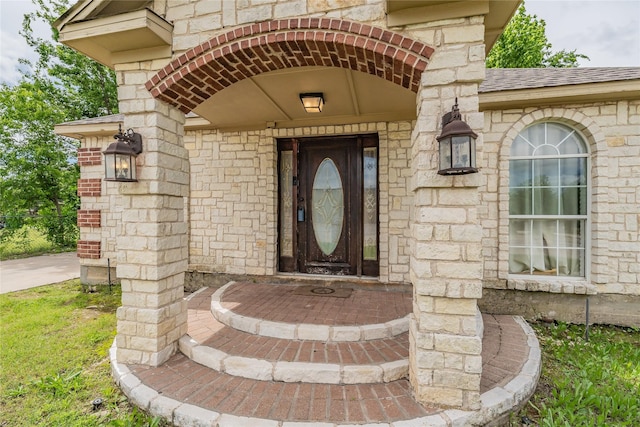 5613 Graham St, Sansom Park, TX 76114 - view of exterior entry featuring a shingled roof and brick siding