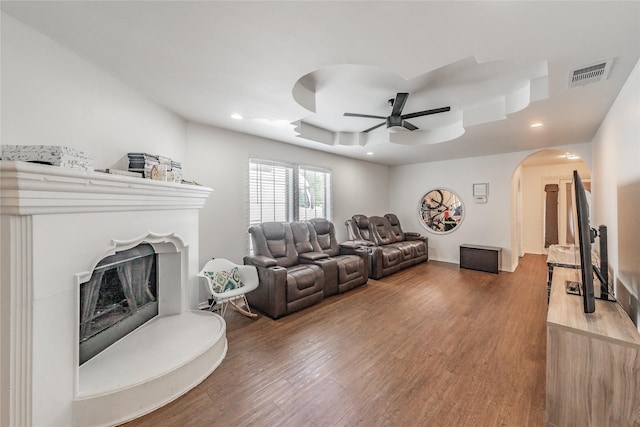 5613 Graham St, Sansom Park, TX 76114 - living room with ceiling fan, arched walkways, wood finished floors, a fireplace with raised hearth, and recessed lighting