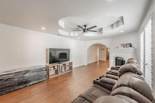 5613 Graham St, Sansom Park, TX 76114 - living room with arched walkways, wood finished floors, a ceiling fan, recessed lighting, and a raised ceiling