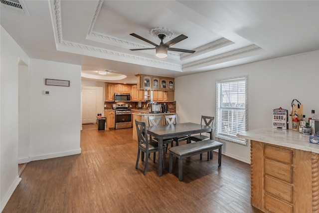 5613 Graham St, Sansom Park, TX 76114 - dining space with a raised ceiling, ceiling fan, baseboards, and wood finished floors